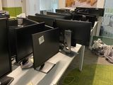 many computers on the desks in this office