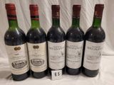 six bottles of red wine are lined up on a table
