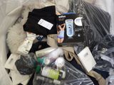 a pile of items in a plastic bag on a bed