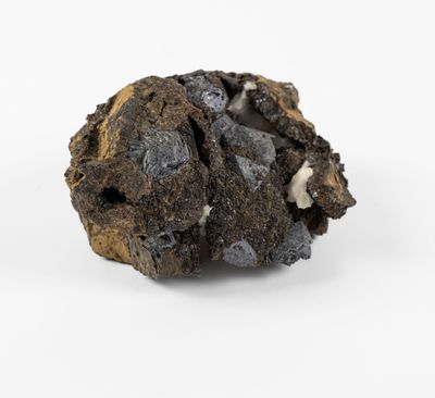 a close up of a piece of black rock on a white surface
