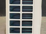 a white air conditioner sitting on the floor