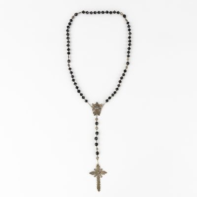 a rosary necklace with a cross on it and black beads