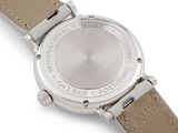 the back of a watch with a brown leather strap on a white surface