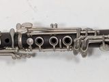 a close up of a clarinet on a white surface