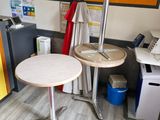 a small table with a lamp on it in the corner of a room