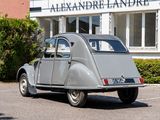 an old car parked in front of a building