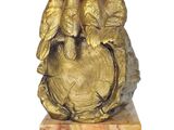 a gold sculpture of three birds sitting on top of a globe
