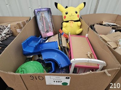 a cardboard box filled with toys and a stuffed animal