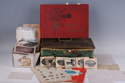 a red suitcase sitting on top of a pile of old books