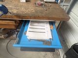 a workbench with a lot of work on it in a garage