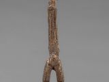 a statue of a man standing on one leg with his hands in the air