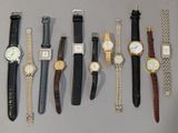 several different types of watches are lined up on a table