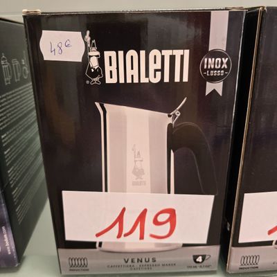 two boxed coffee pots sitting on top of a table next to each other