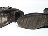 two pairs of shoes that are on a white surface