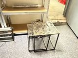 a small table that has a zebra print seat on it