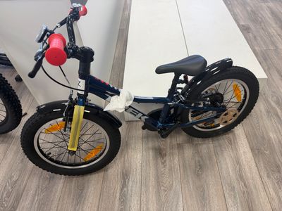 two bikes that are parked next to each other on the floor