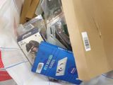 a box of electronics sitting on top of a bed