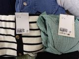 three pairs of socks and a sweater on a table