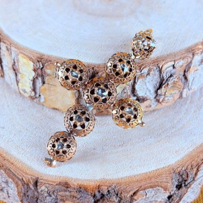 gold plated cross brooch with black and white stones