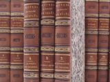 many books stacked on top of each other on a table