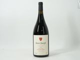 une bouteille de vin posée sur une table blanche