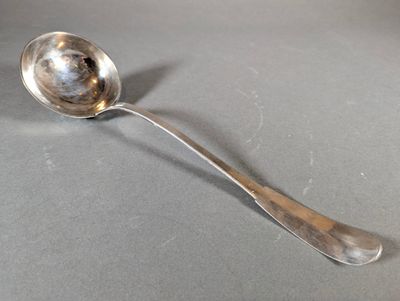 a silver spoon with a spoon handle on a table