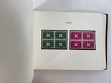 an open book with a picture of four different stamps on it