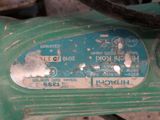 a close up of a green machine with a blue label on it
