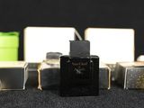 three bottles of perfume are lined up on a table