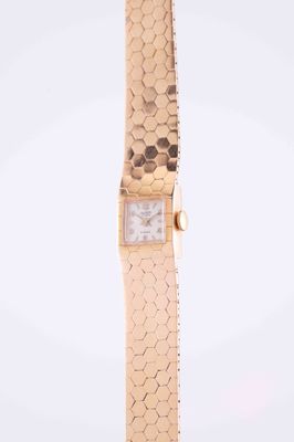 a close up of a gold watch with a white face