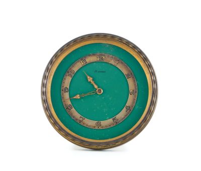 a clock that is sitting on a white surface