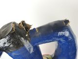 a sculpture of a blue horse with a black mane