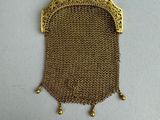 a gold chain purse with a chain clasp