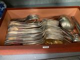 many spoons and spoons in a box on the counter