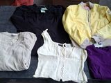 a lot of clothes that are sitting on a table