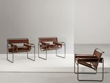 three chairs in a room with a white floor and a white wall