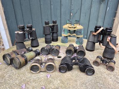 many different types of binoculars sitting on the ground
