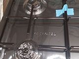 a black stove top with a metal burner on top of it