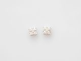 a pair of diamond stud earrings on a white background