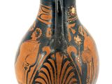 a black and orange vase sitting on a white surface