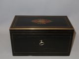 an image of a black and gold box with a flower design on it