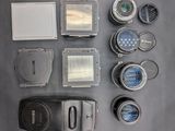 many different types of cameras and lenses laid out on a table