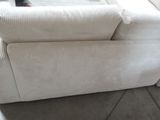 a white couch that is sitting on the floor in a room
