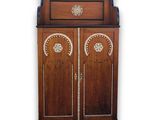 a wooden cabinet with two doors and a drawer on top of it