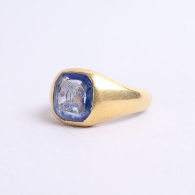 a close up of a gold ring with a blue sapphire stone