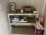 a kitchen with a sink and a shelf in the corner