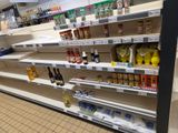 many shelves in the store that are filled with different types of beverages