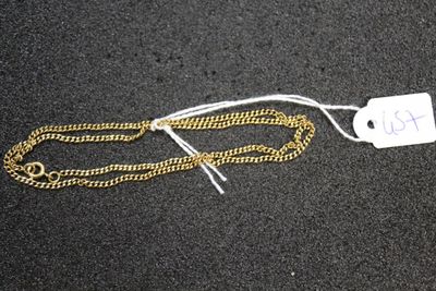 a close up of a gold chain with a price tag on it