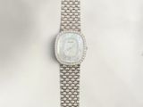an image of a woman ' s wrist watch with a white mother of pearl dial