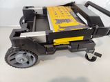 a black and yellow toy truck with wheels on a white surface